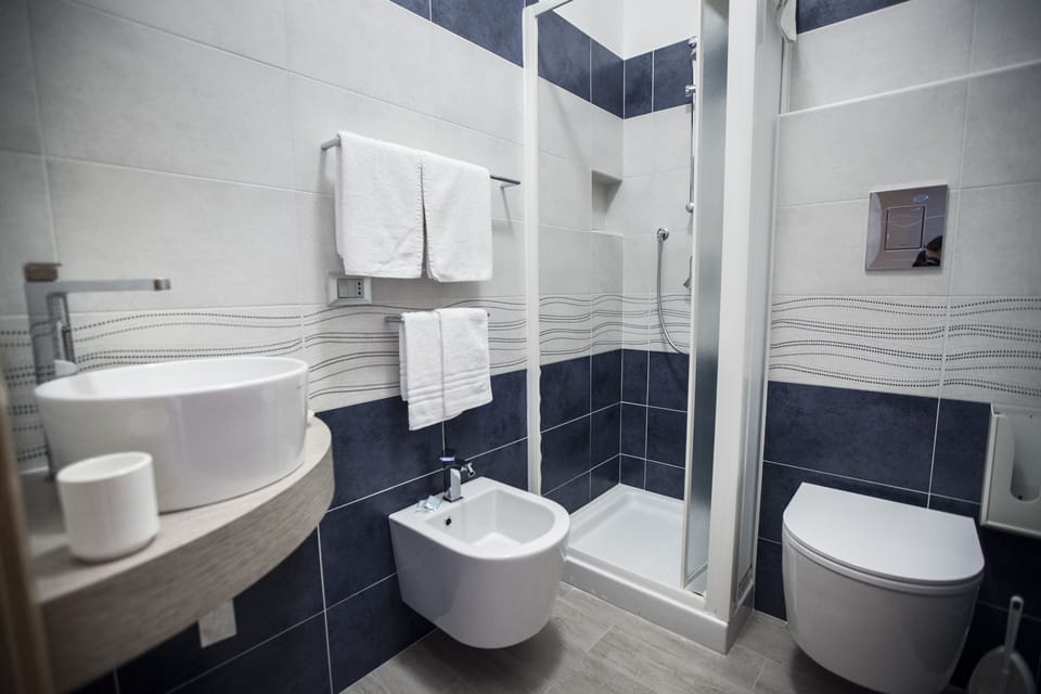 Economy Double Room, Balcony, Partial Sea View | Bathroom | Shower, free toiletries, hair dryer, towels