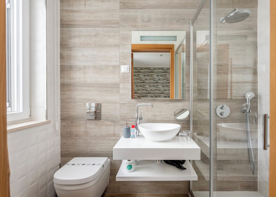 Bathroom | Shower, rainfall showerhead, hair dryer, bathrobes