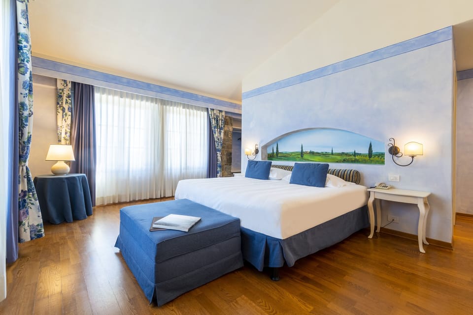 Superior Room | Minibar, in-room safe, desk, iron/ironing board