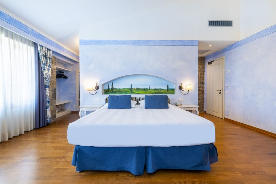 Superior Room | Minibar, in-room safe, desk, iron/ironing board