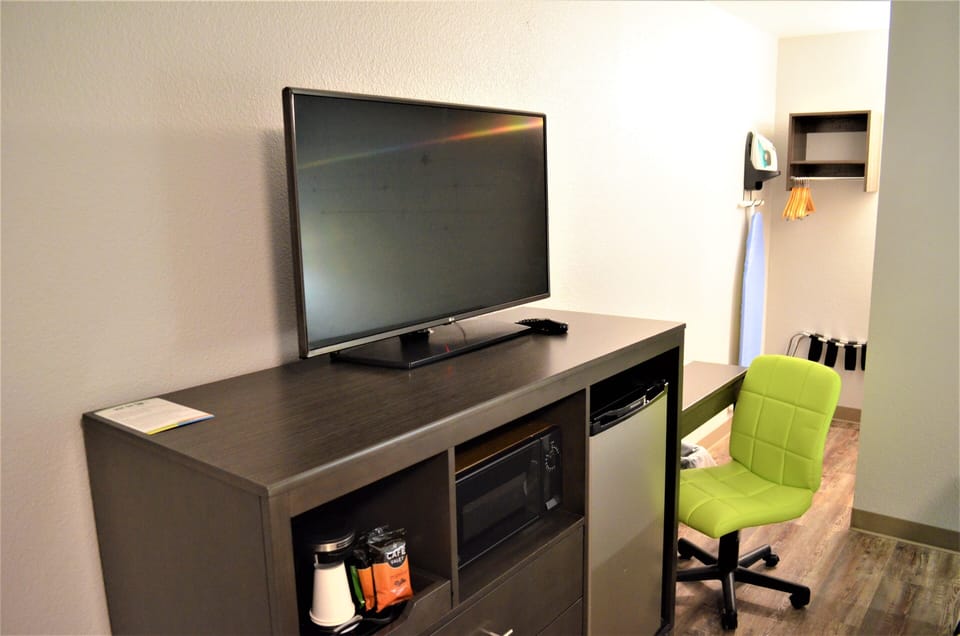 Desk, laptop workspace, blackout drapes, iron/ironing board