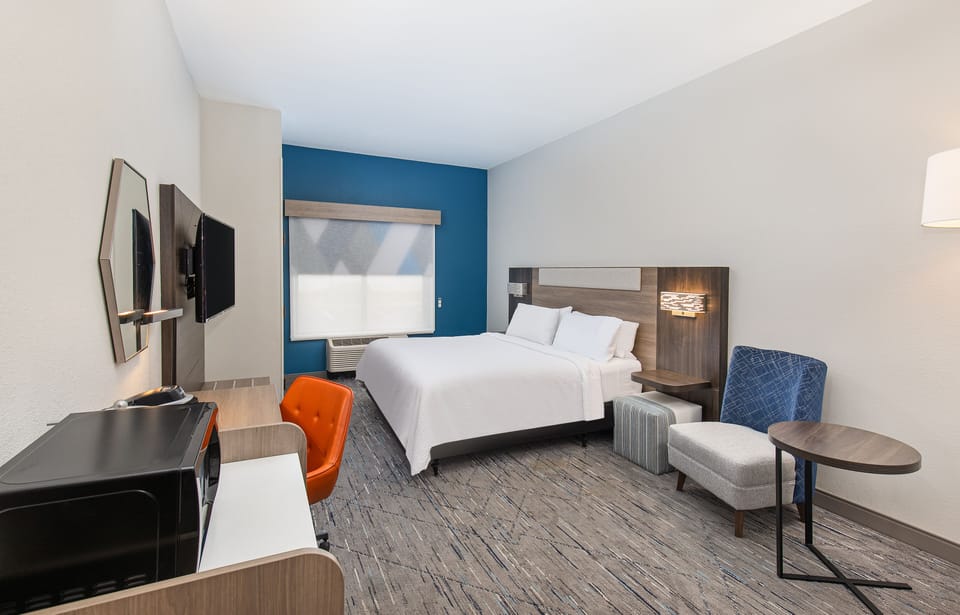 Hypo-allergenic bedding, desk, laptop workspace, blackout drapes