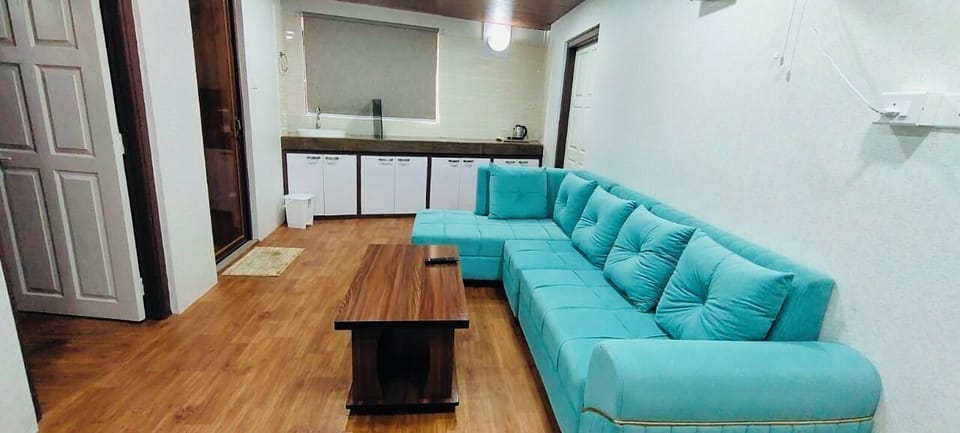 Family Suite, Balcony, Hill View | Living area | TV