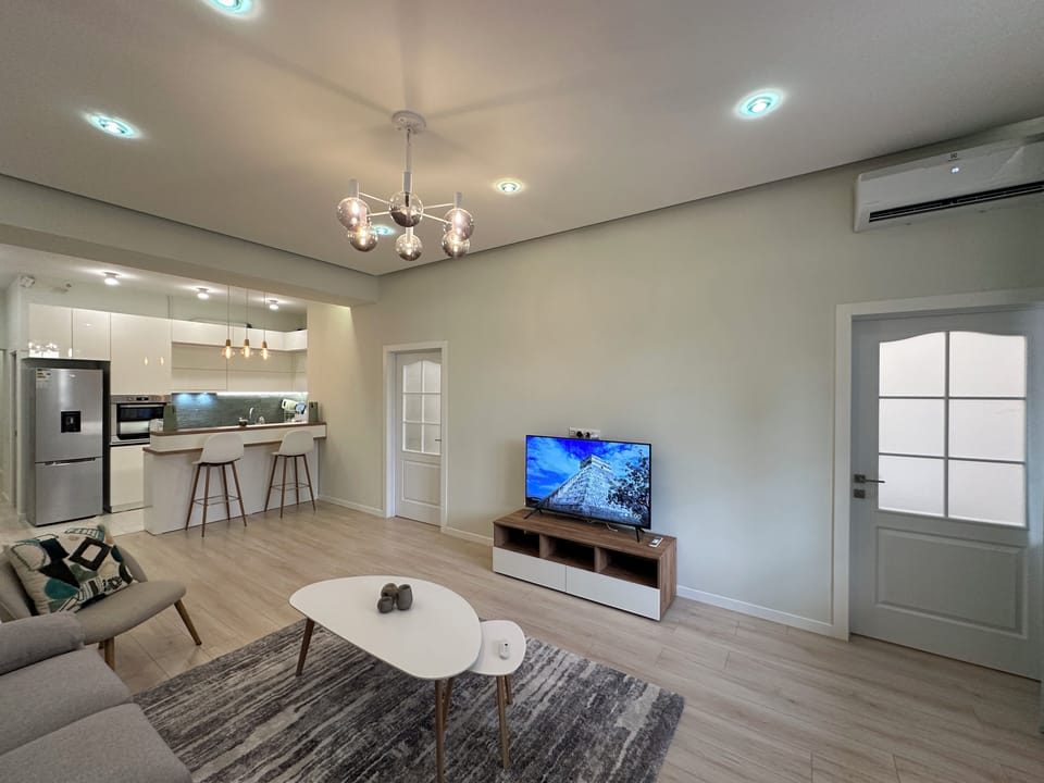Family Apartment | Living area | 50-inch flat-screen TV with cable channels