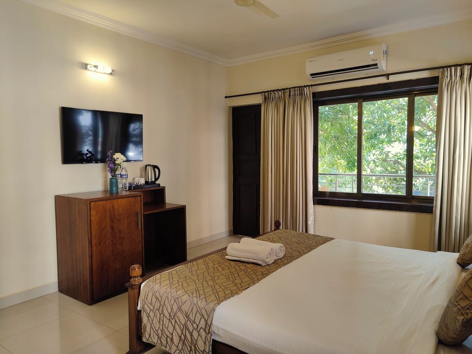 Suite, Balcony, Garden View | Desk, laptop workspace, blackout drapes, iron/ironing board