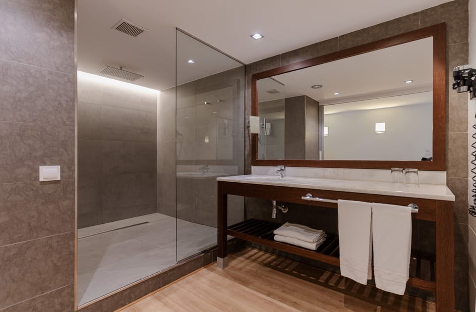 Shower, rainfall showerhead, designer toiletries, hair dryer
