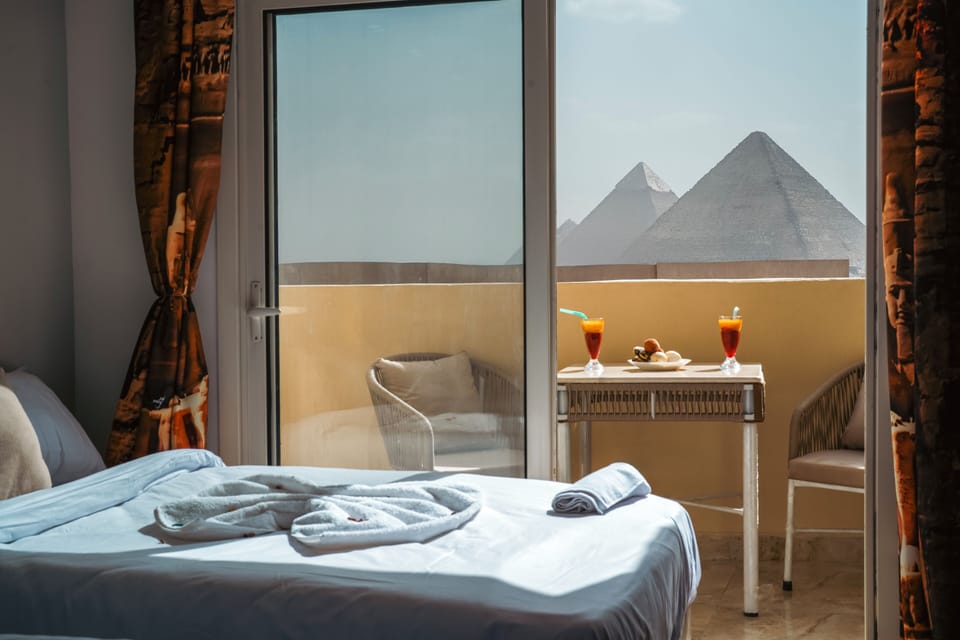 Triple Room with Balcony Pyramids View | Egyptian cotton sheets, premium bedding, down comforters, minibar