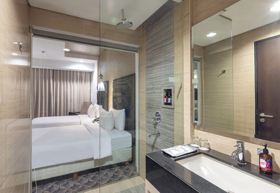 Deluxe Twin | Bathroom | Shower, hair dryer, towels, soap