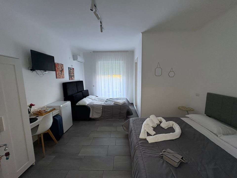 Deluxe Quadruple Room, Balcony, Park View | Desk, laptop workspace, free WiFi