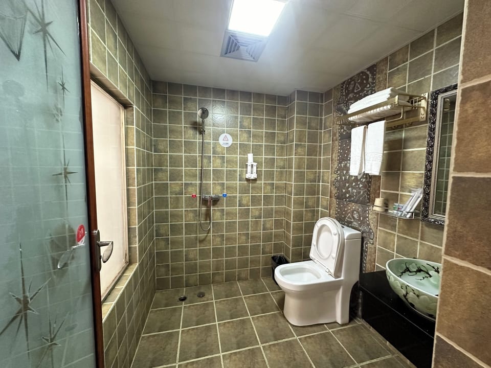 Shower, free toiletries, slippers, towels