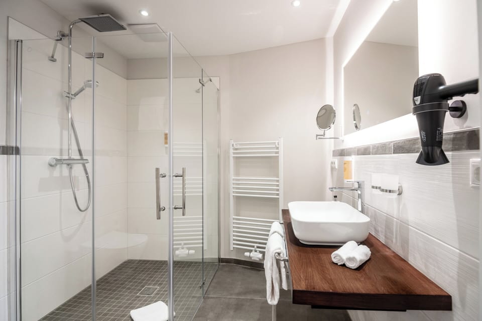 Shower, rainfall showerhead, hair dryer, towels