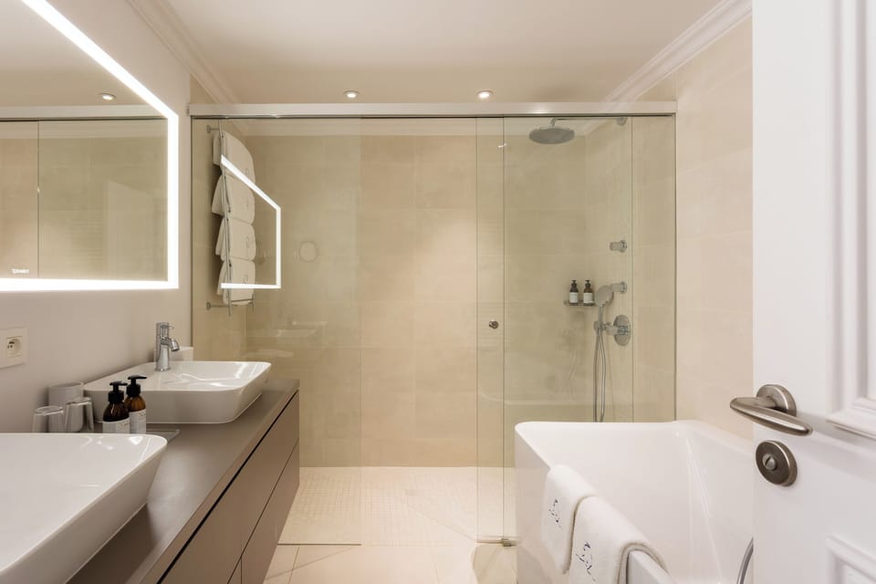 Designer toiletries, hair dryer, bathrobes, slippers