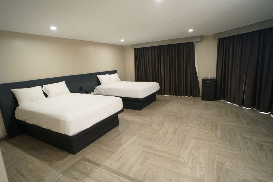 Family Room, 2 Queen Beds, Non Smoking | Premium bedding, desk, iron/ironing board (on request), WiFi (free)