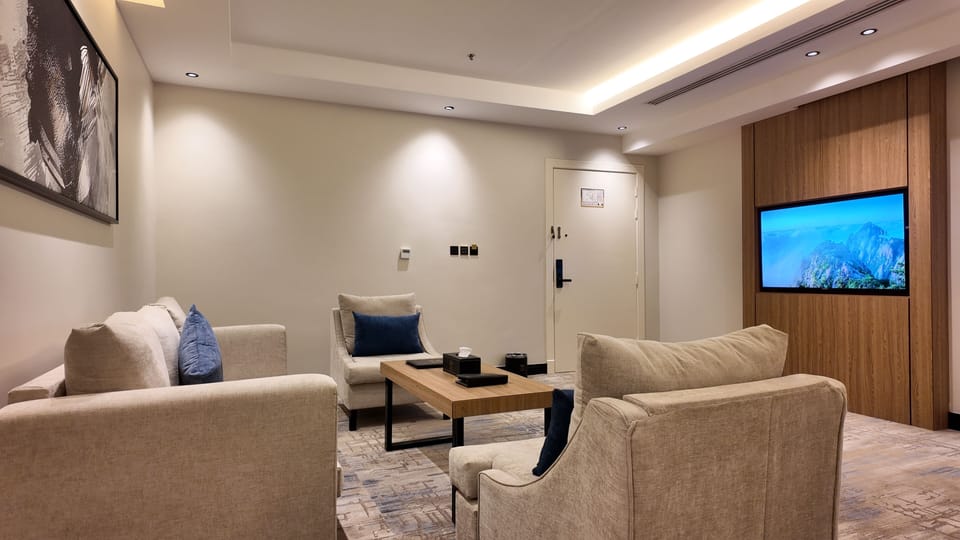 Deluxe Studio Suite | Living area | 75-inch Smart TV with satellite channels
