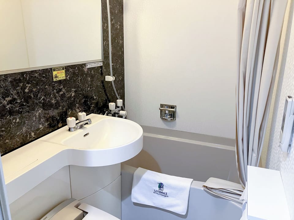 Combined shower/tub, free toiletries, hair dryer, slippers