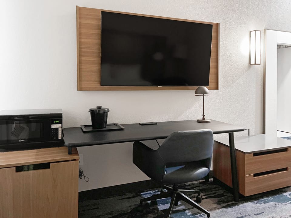 Desk, laptop workspace, blackout drapes, iron/ironing board