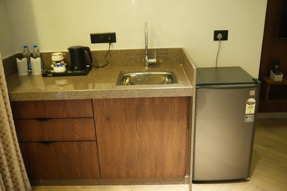 Superior Suite, City View | Private kitchen | Mini-fridge, microwave, dishwasher, cookware/dishes/utensils