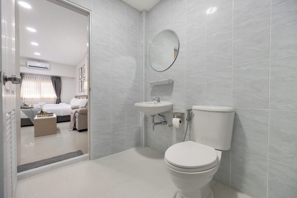 Deluxe Quadruple Room, 2 Queen Beds, Non Smoking | Bathroom | Shower, hair dryer, towels, soap