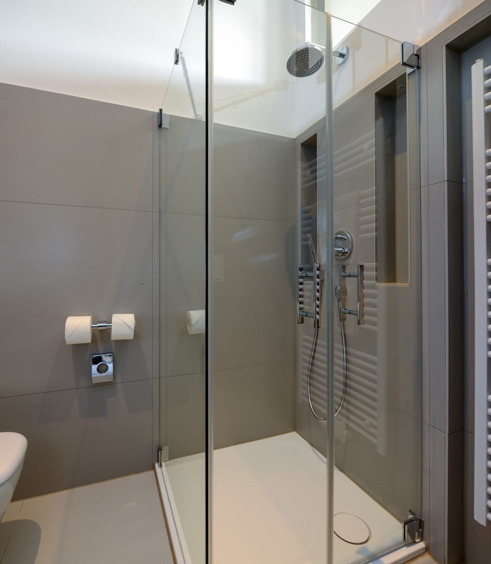 Shower, rainfall showerhead, slippers, towels