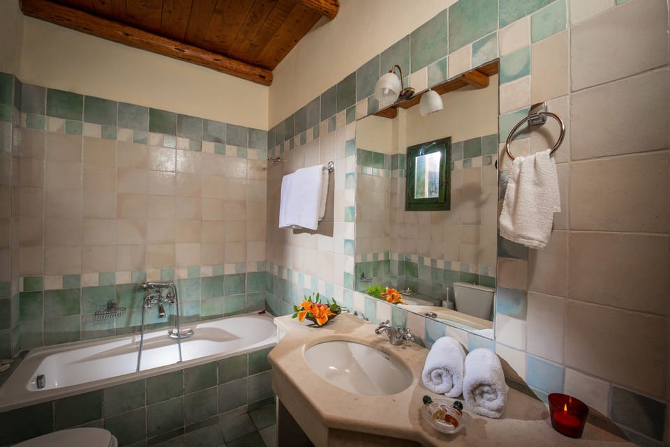 Designer toiletries, hair dryer, slippers, towels