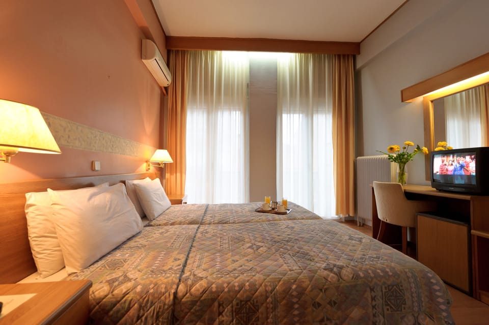 Twin Room | Minibar, in-room safe, iron/ironing board, free WiFi