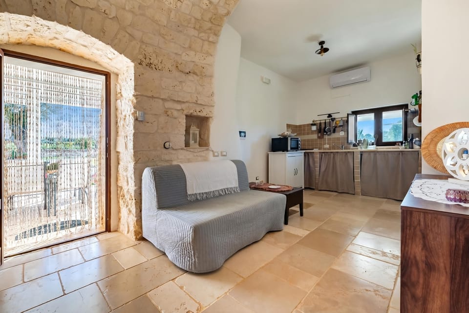 Family Villa, Multiple Bedrooms (Trullo ConoSolo With Pool) | Living area | 21-inch Smart TV with digital channels, fireplace