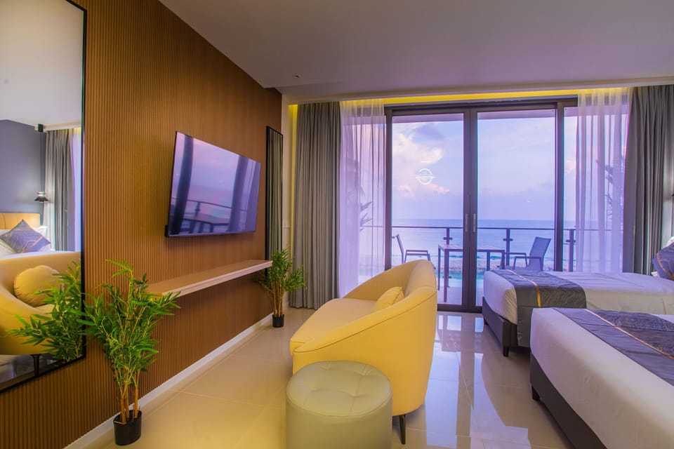 Deluxe Triple Room, Balcony, Sea View | Minibar, in-room safe, desk, laptop workspace