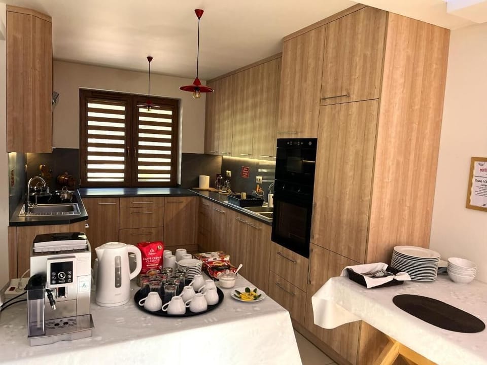 Full-size fridge, dishwasher, cookware/dishes/utensils, dining tables