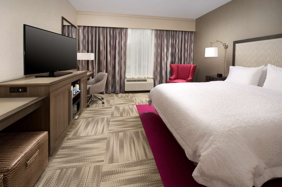 Premium bedding, desk, laptop workspace, blackout drapes