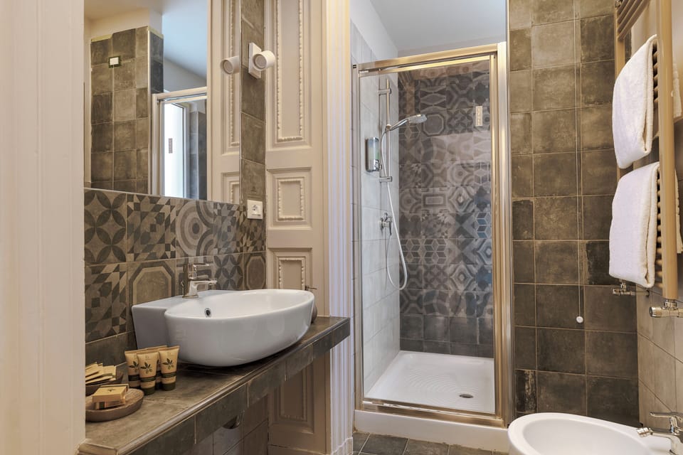 Deluxe Room, Balcony, City View | Bathroom | Shower, hair dryer, slippers, bidet