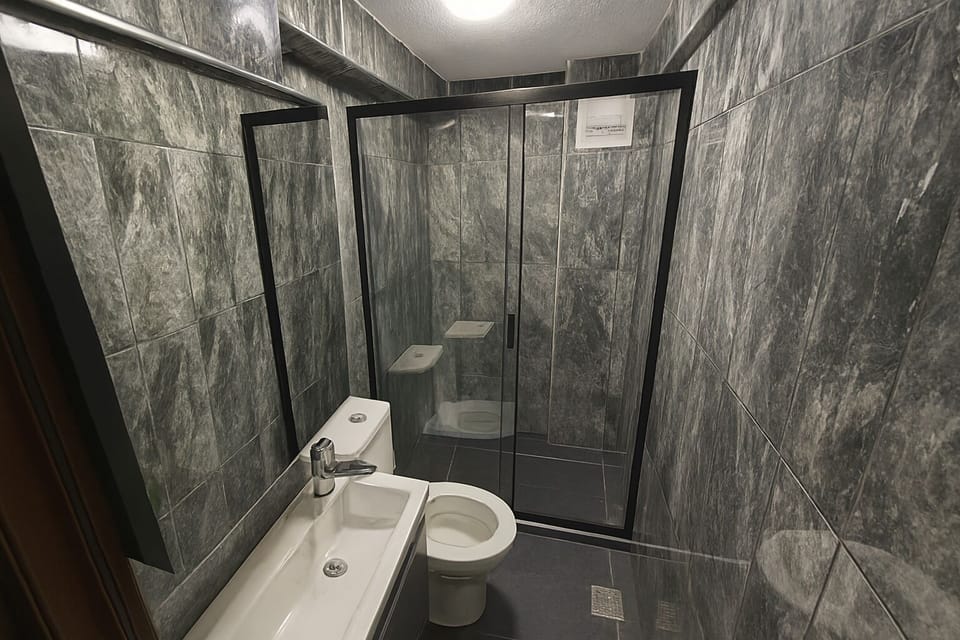 Premium Quadruple Room | Bathroom | Shower, hair dryer, slippers, towels