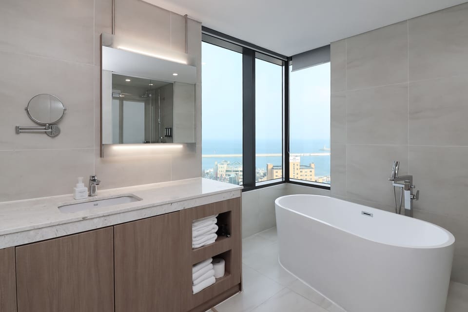 Deluxe Family Twin Half Ocean | Bathroom | Hair dryer, slippers, bidet, towels