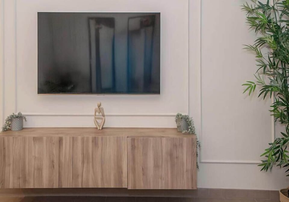 Apartment, Balcony, City View | Living area | 55-inch Smart TV with cable channels