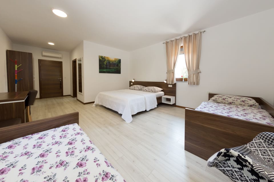 Family Quadruple Room, Garden View | Memory foam beds, minibar, in-room safe, desk