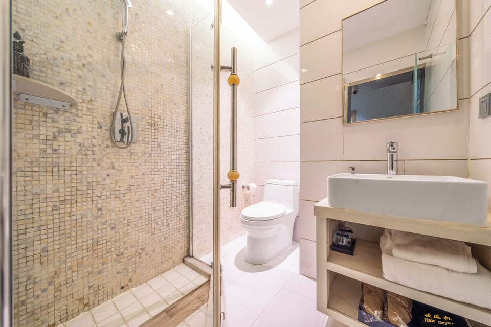 Shower, hair dryer, slippers, towels