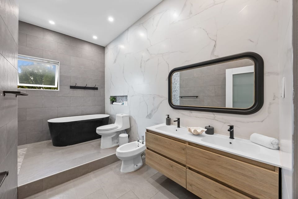 The Lotus Suite | Bathroom | Shower, hair dryer, slippers, towels