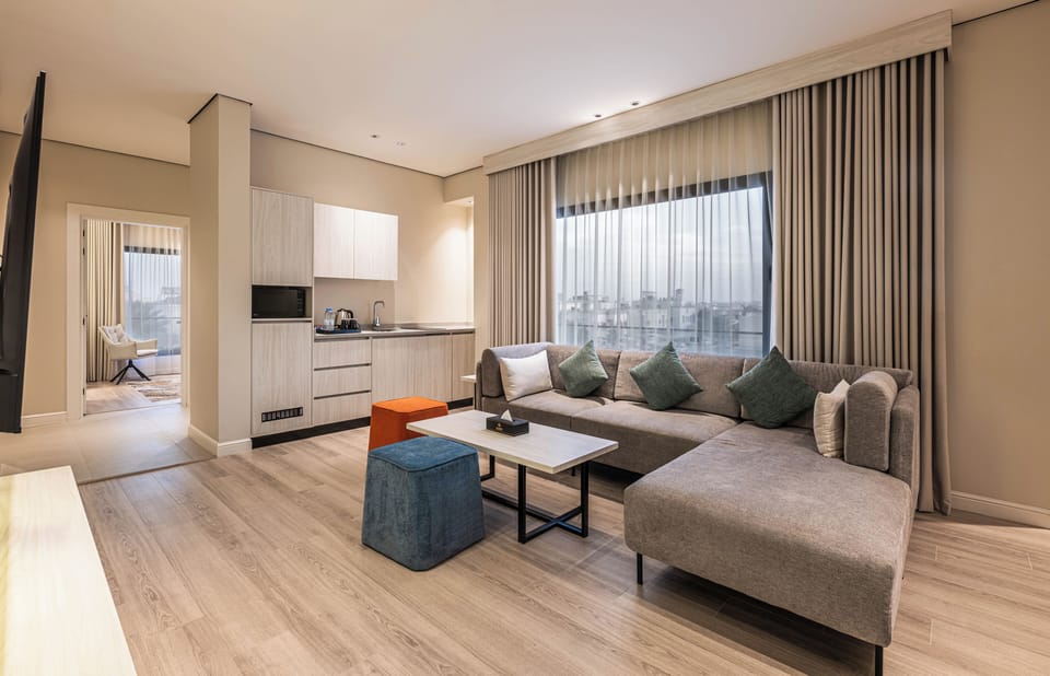 Deluxe Suite | Living area | 55-inch LCD TV with satellite channels, printers