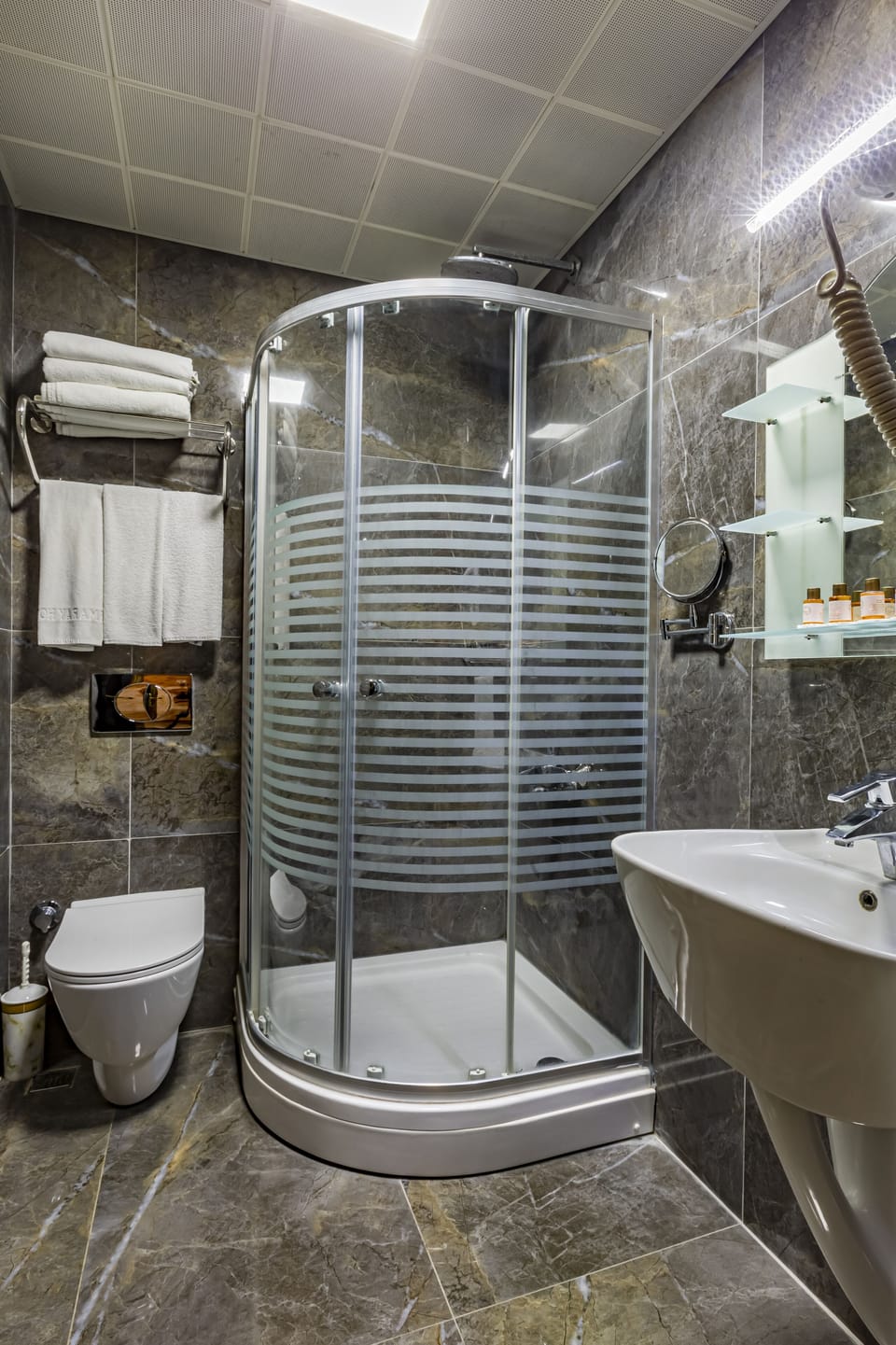 Shower, designer toiletries, hair dryer, bathrobes