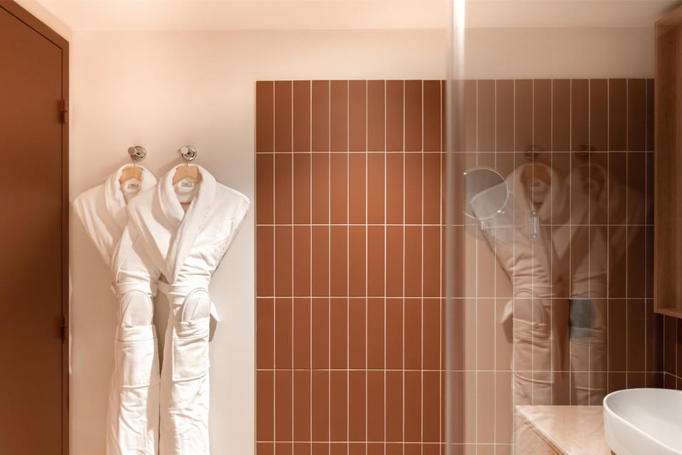 Shower, designer toiletries, hair dryer, bathrobes