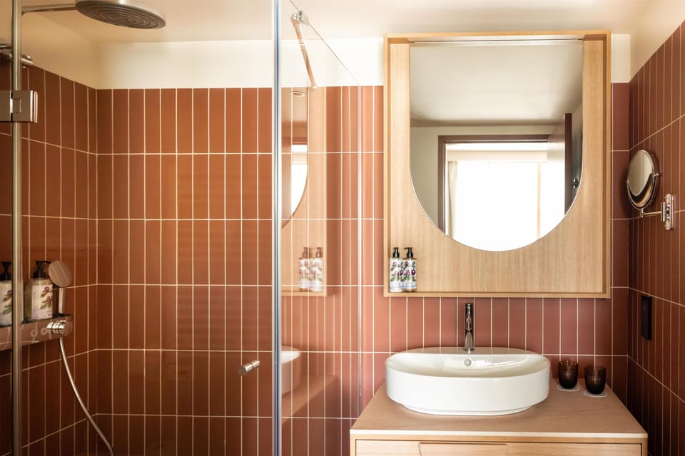 Shower, designer toiletries, hair dryer, bathrobes