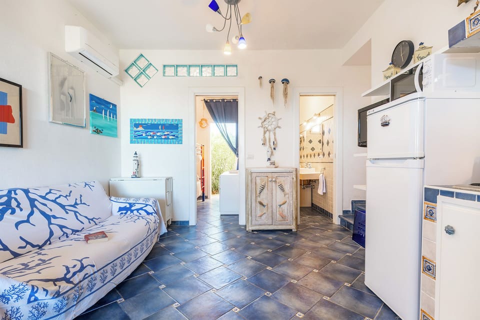 Apartment, Sea View | Living area | Flat-screen TV