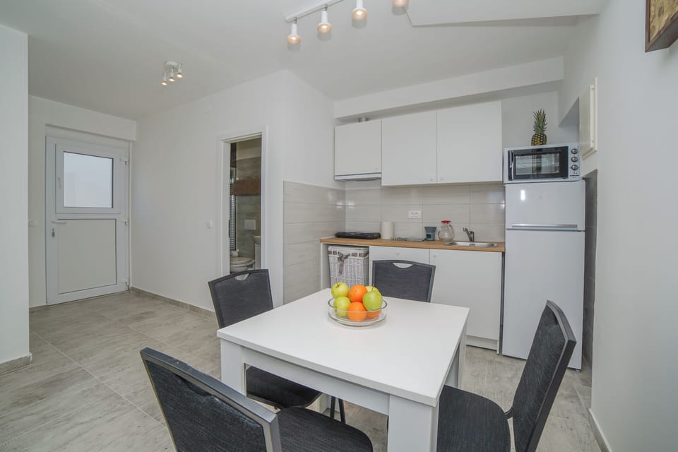 Apartment, Balcony, Sea View | Private kitchen | Electric kettle, dining tables