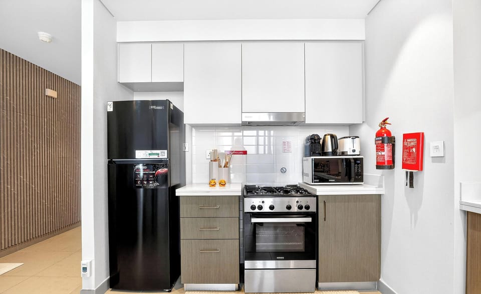 Standard Apartment, Sea View | Private kitchen | Toaster, cleaning supplies, freezer, dining tables
