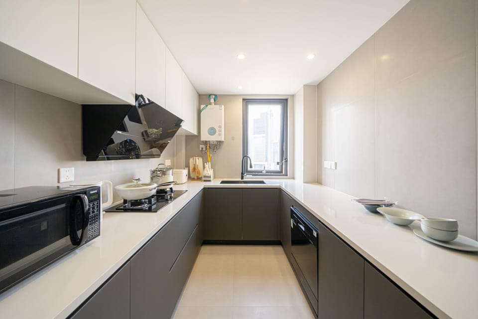 Elite Apartment | Private kitchen | Full-size fridge, stovetop, cookware/dishes/utensils, cleaning supplies