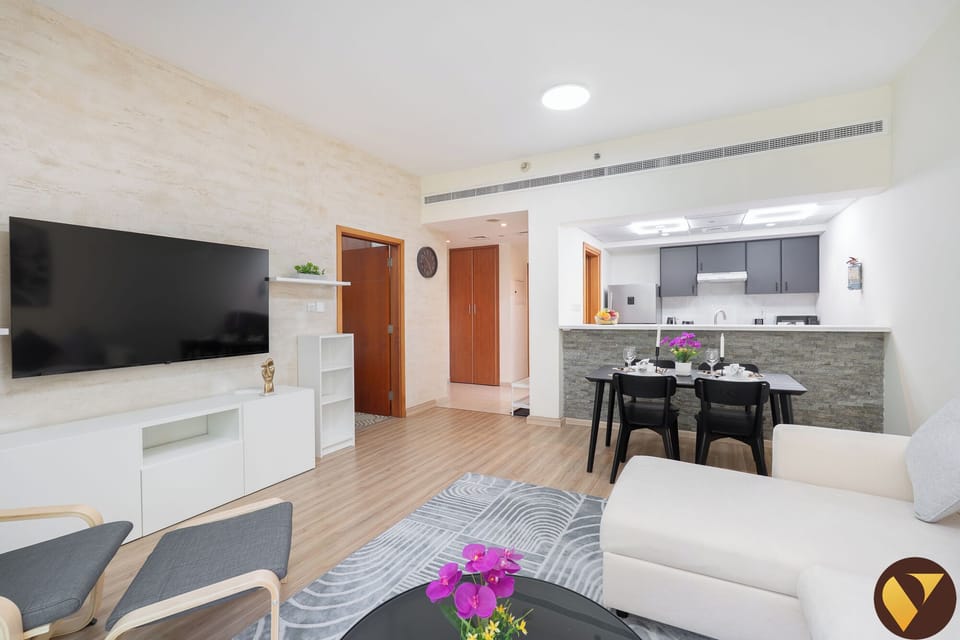 Luxury Apartment, Balcony, Garden View | Living room | 65-inch Smart TV with cable channels