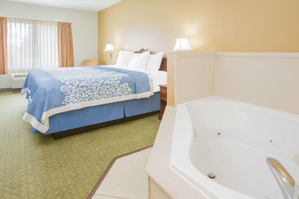 Room, 1 King Bed, Jetted Tub | Desk, iron/ironing board, free cribs/infant beds, rollaway beds