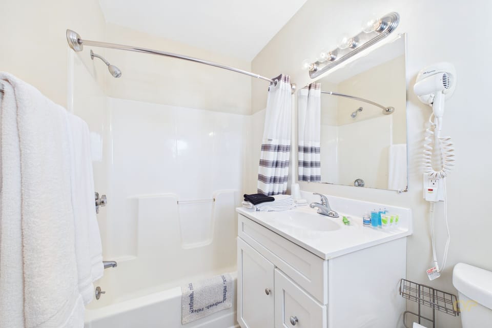 Separate tub and shower, towels, soap, shampoo