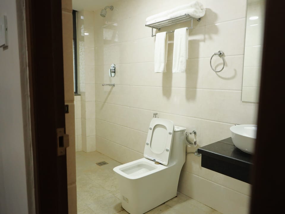 Shower, hair dryer, slippers, towels