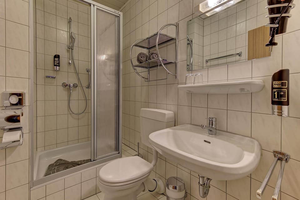 Shower, hair dryer, towels, toilet paper