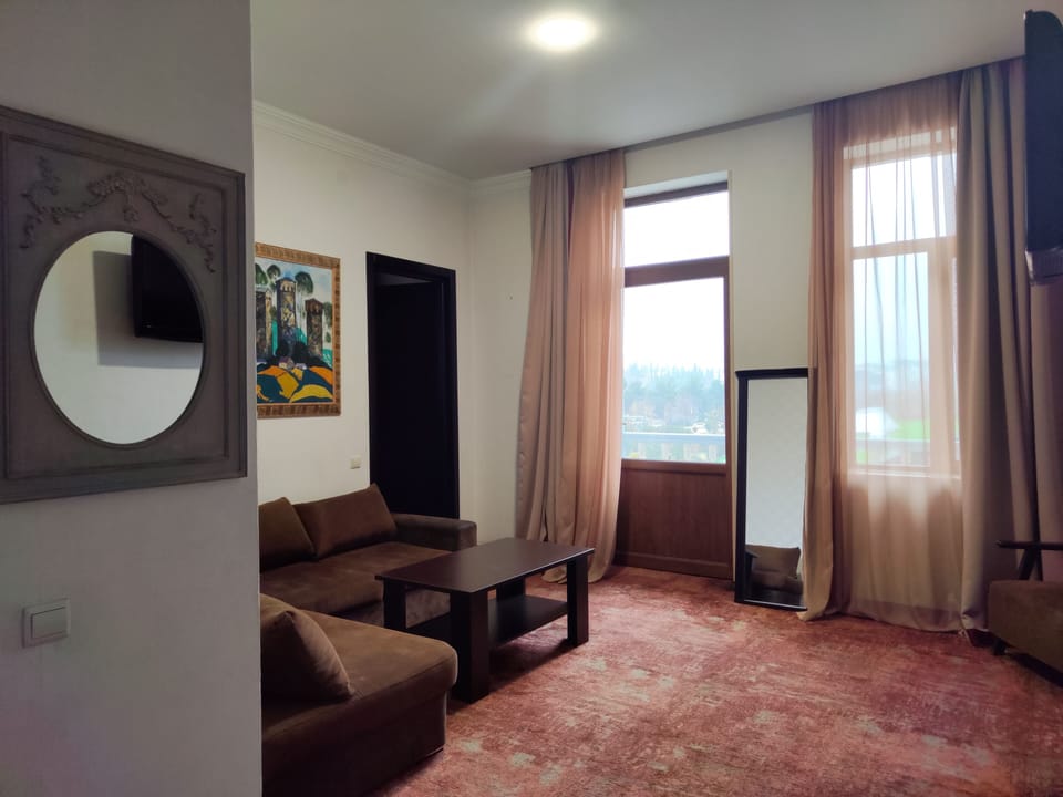 Luxury Suite, Balcony, Mountain View | Living area | TV